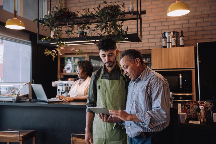 A business owner reviewing figures on a laptop with an advisor